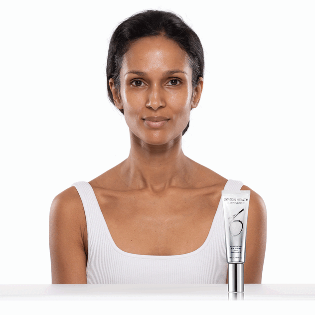 Woman applying Illuminating AOX Serum Serum